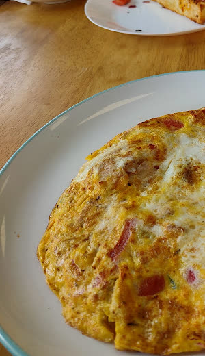A golden omelette on a wooden table